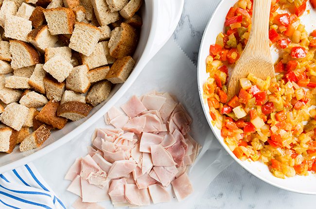 Layering bread and veggies for southwest breakfast casserole