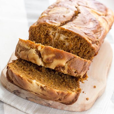 Up close picture of sliced loaf of pumpkin cream cheese bread