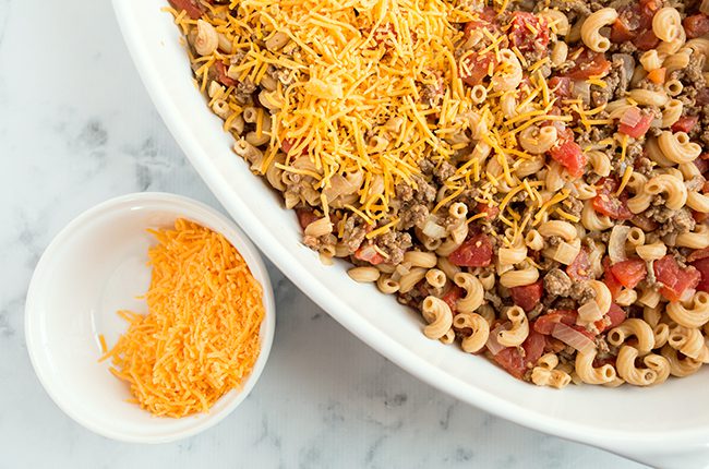 Overhead picture of assembling cheeseburger macaroni casserole