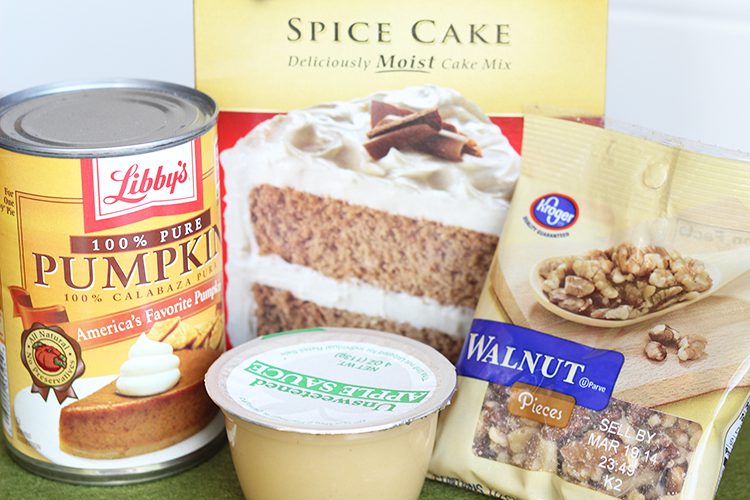 Ingredients for pumpkin spice muffins stacked on a counter