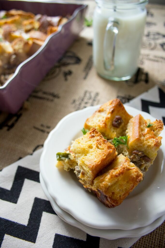 Small white saucers stacked with a single serving of turkey sausage breakfast casserole