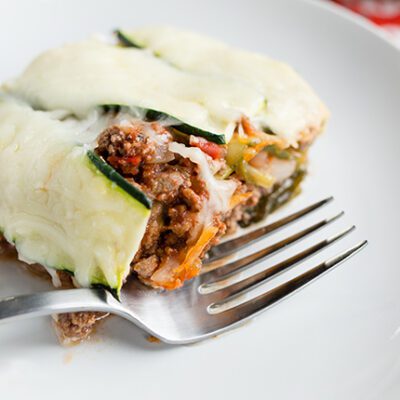 Overhead picture of slice f zucchini lasagna on white plate