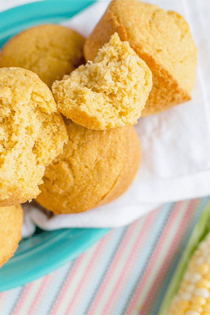 Up close picture of cornbread muffins in half showing inside