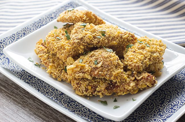 Crispy fried chicken recipe on a white plate that is sitting on top of a blue plate