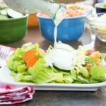pouring Greek Yogurt Ranch Dressing Recipe over salad
