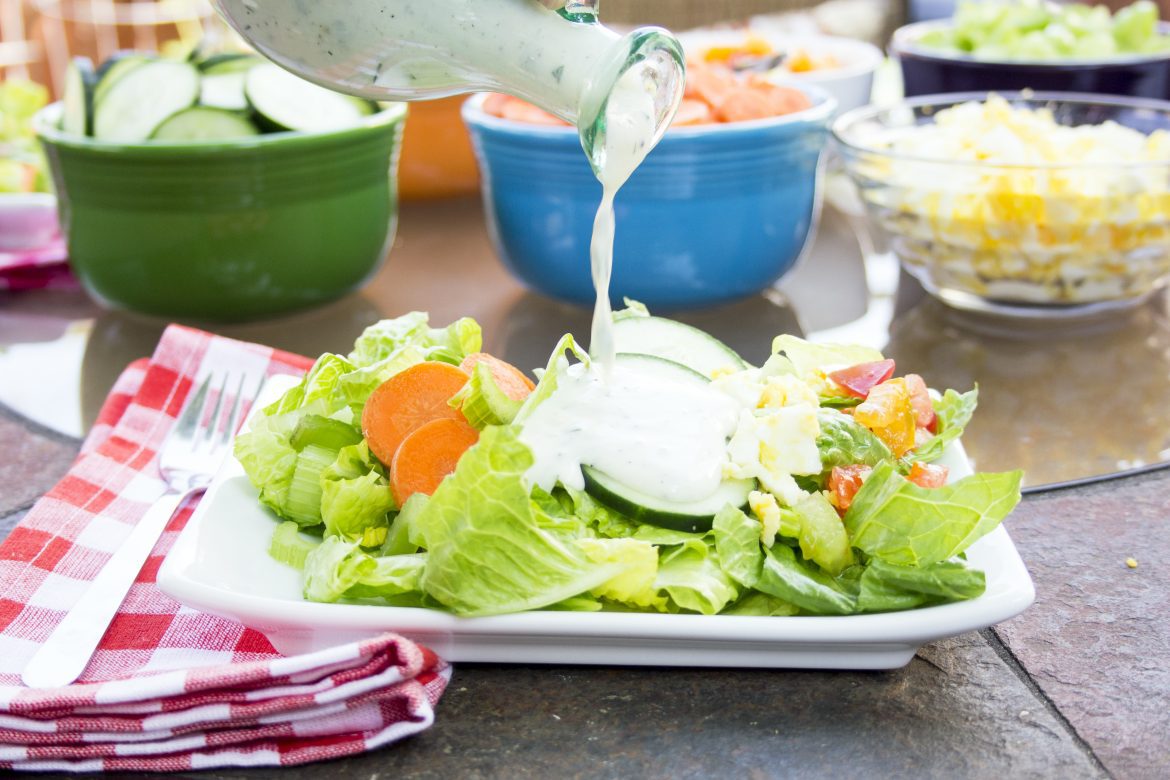 pouring Greek Yogurt Ranch Dressing Recipe over salad