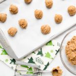 gingerbread cookie dough balls on a baking sheet