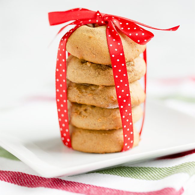 soft chewy gingerbread cookies in a stack with a red ribbon