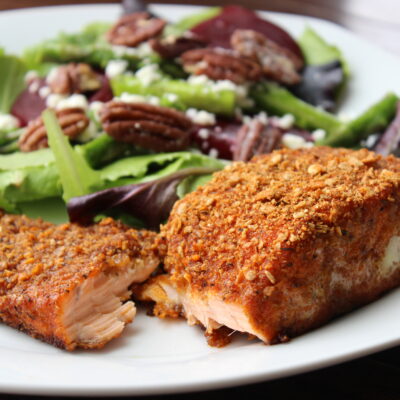 Blackened Salmon on white plate with salad