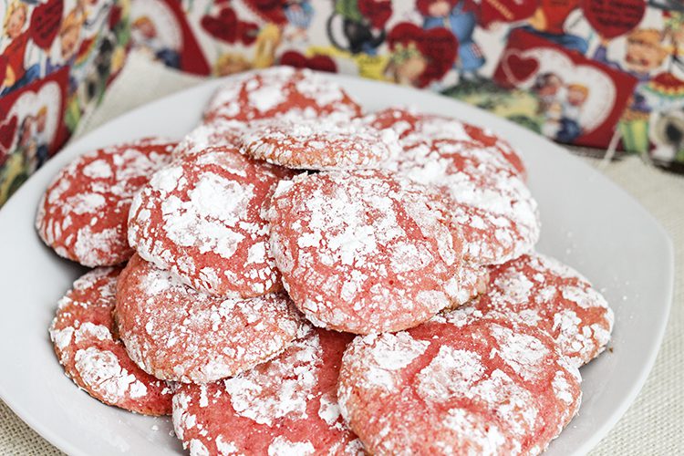 A white plate with several baked strawberry cake mix cookies 