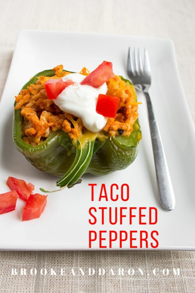 Single green bell pepper on white plate with fork