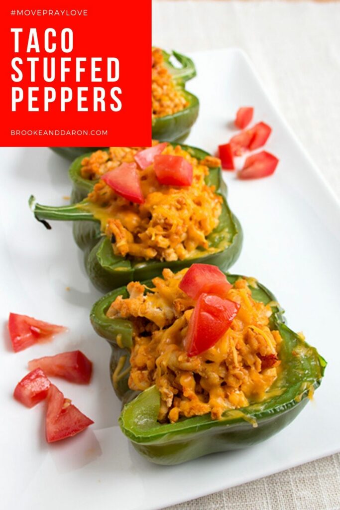 Three bell peppers stuffed with chicken on white plate