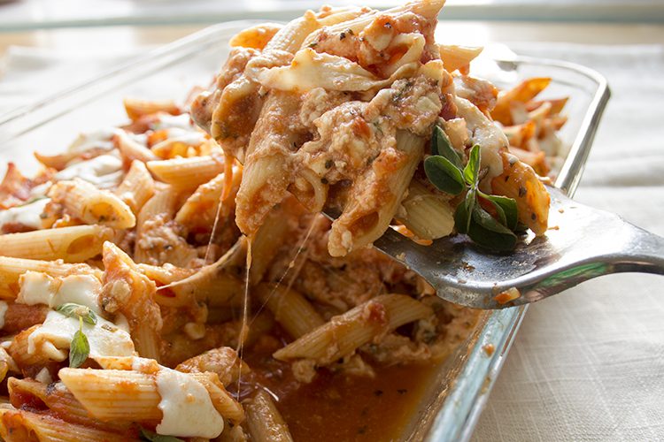 lasagna casserole being dished out with a large spoon