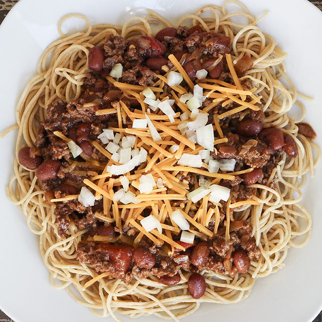 Square image of cincinnati chili recipe over spaghetti