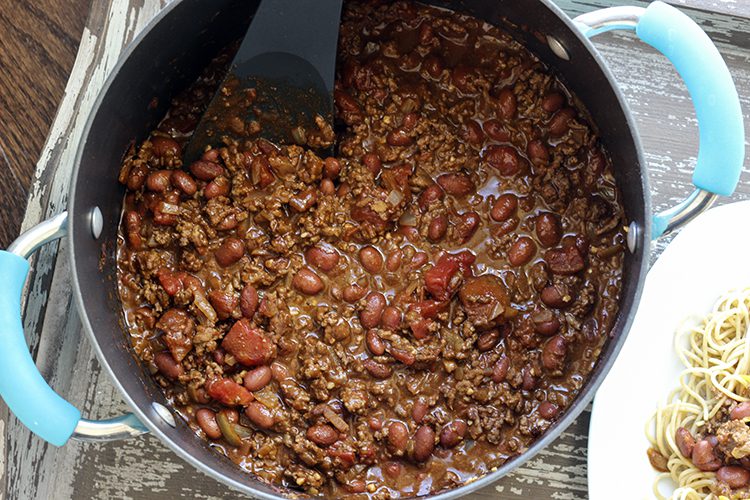 Stirring Cincinnati chili recipe in large dutch oven