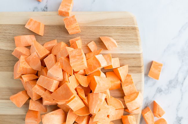 Diced sweet potatoes on cutting board