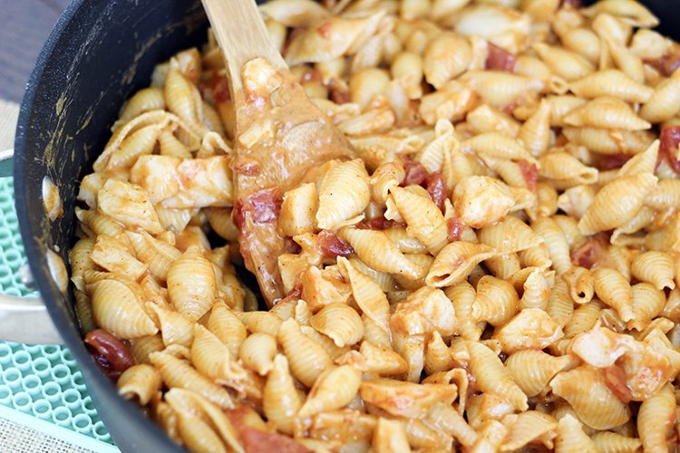 Lobster mac and cheese being cooked in a large stockpot