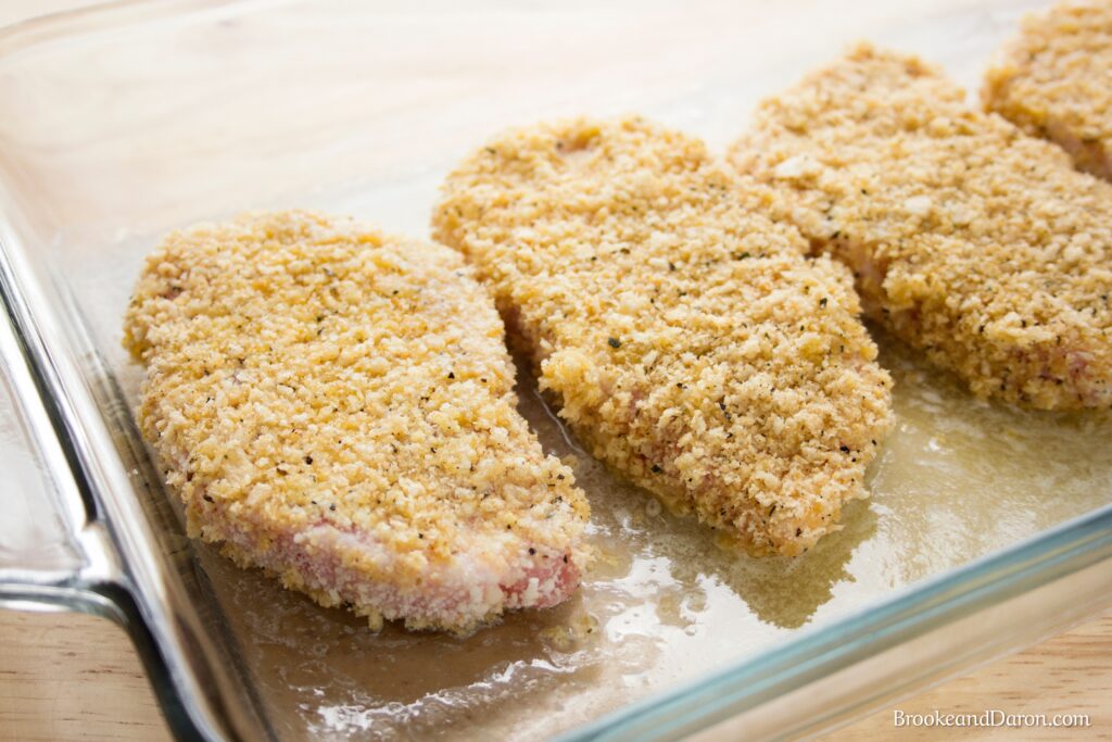 Parmesan pork chops on baking sheet