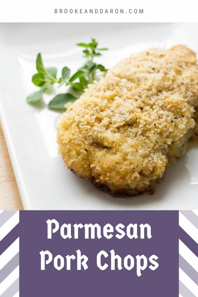 Parmesan pork chop on white plate with parsley