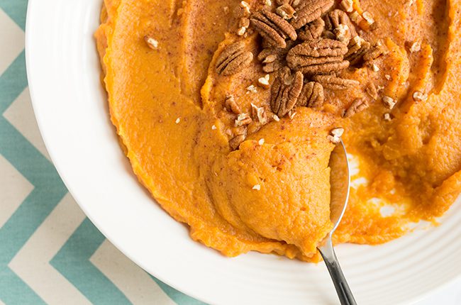 Sweet potatoes in a bowl with a large spoon