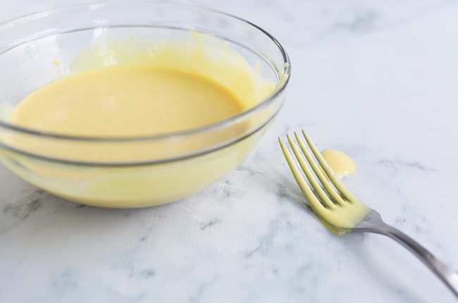 glass bowl with honey mustard dressing recipe and fork