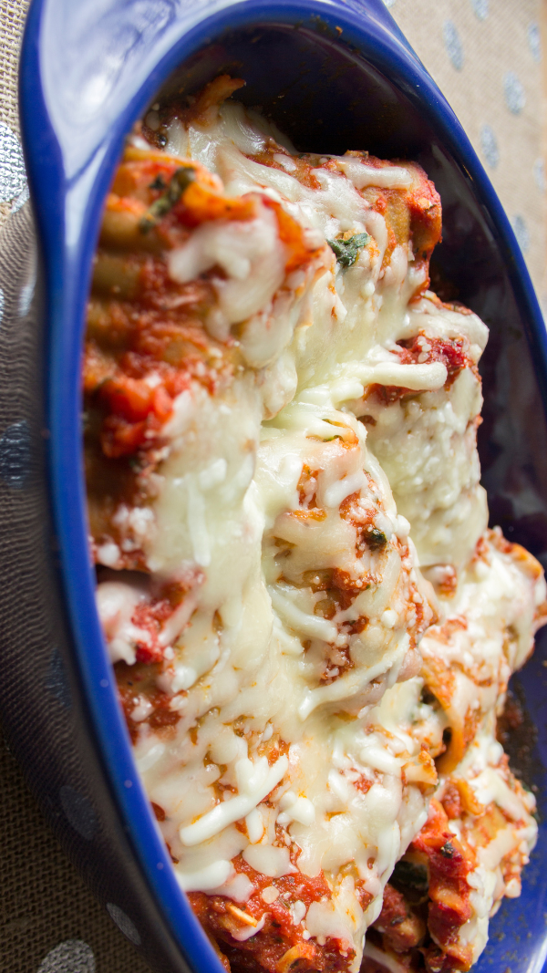 lasagna roll ups baked in blue baking dish