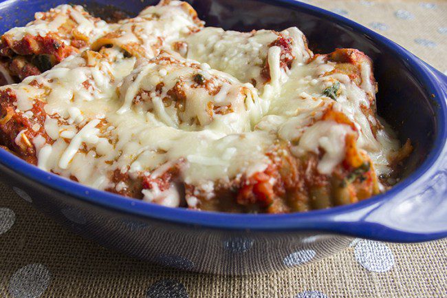 lasagna roll ups baked in blue baking dish