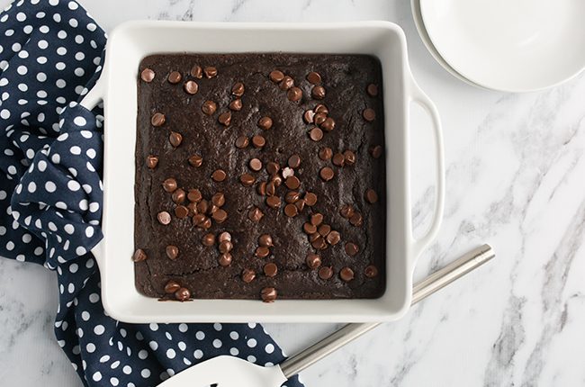 overhead shot of black bean brownies baked with chocolate chips on top