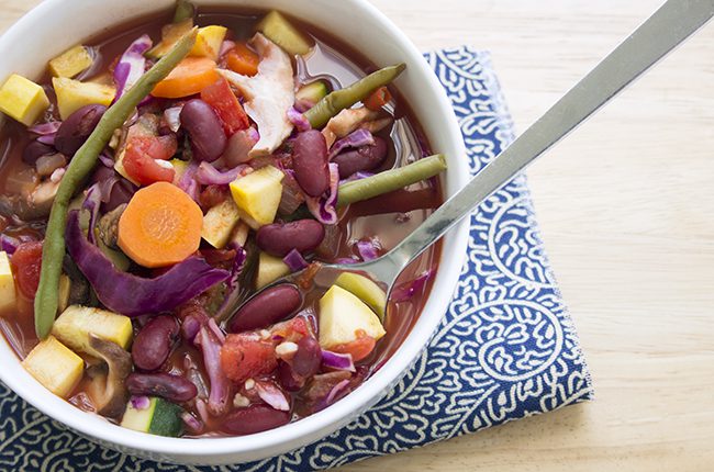 Simple Cabbage Soup in a large white bowl on a blue and white napkin