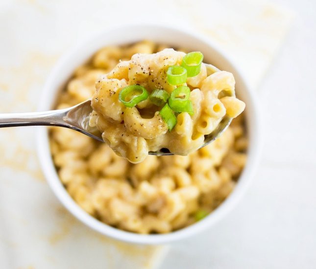 Overhead picture of a spoon full of homemade healthy mac and cheese