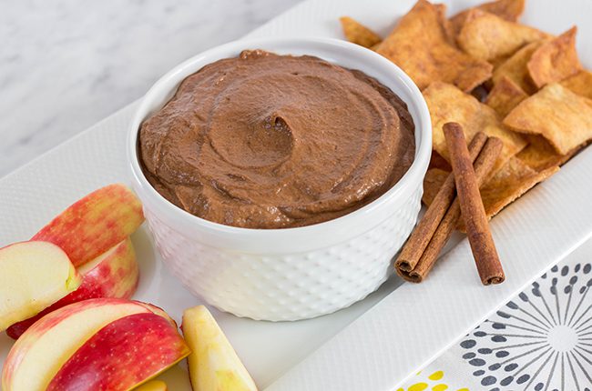 chocolate pumpkin dip in a white bowl with apples