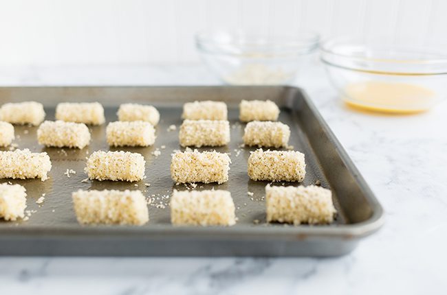 Mozzarella bites sitting on a baking sheet