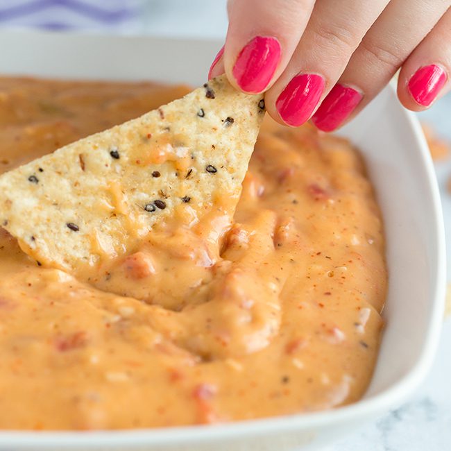 Square image of healthy queso dip recipe in white bowl