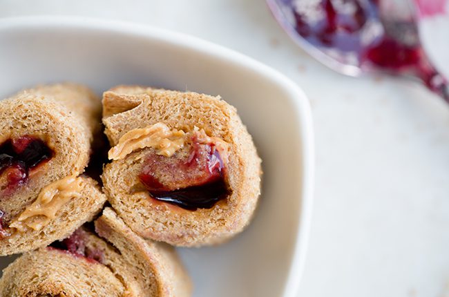 Overhead picture of peanut butter and jelly rolls in white bowl