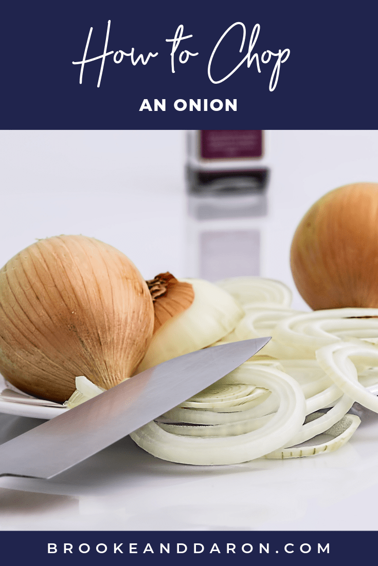 Onions laying on a table partially sliced with a knife to represent how to cut an onion