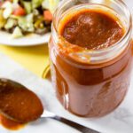 A mason jar filled with homemade enchilada sauce recipe