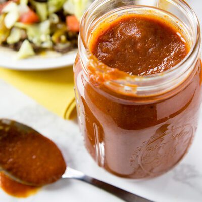 A mason jar filled with homemade enchilada sauce recipe