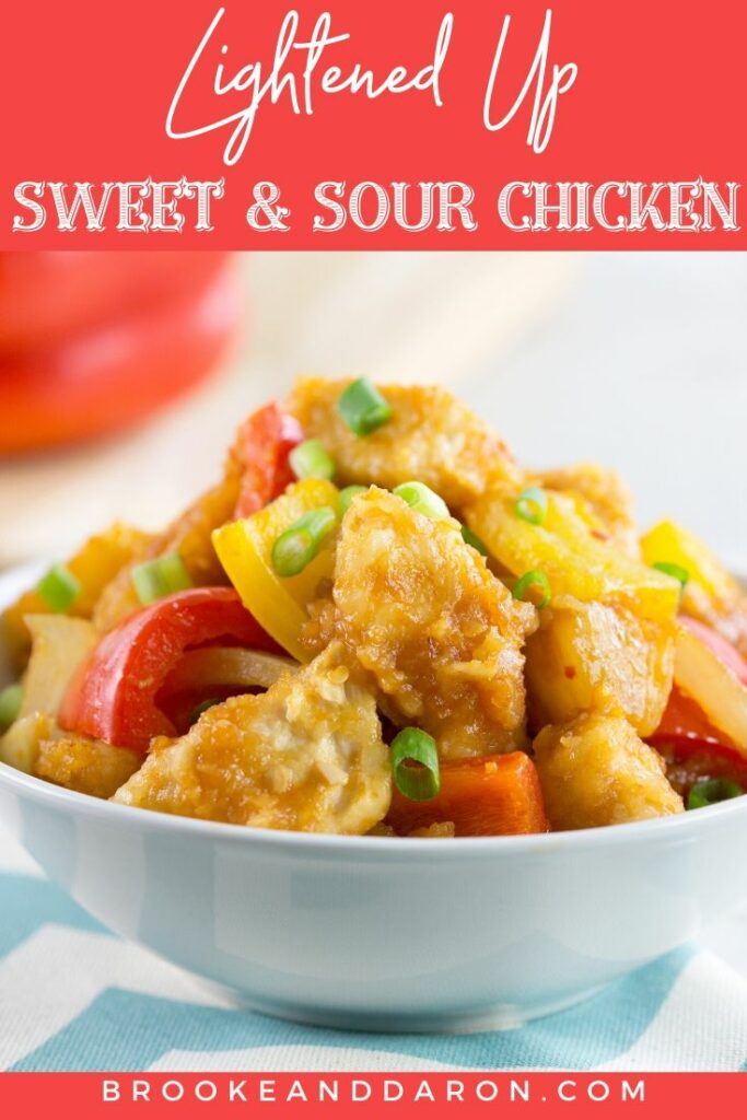 Baked sweet and sour chicken in a white bowl on blue and white cloth napkin