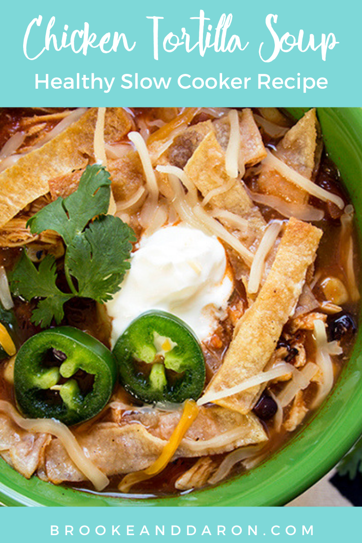 Close up of a bowl of tortilla soup with jalapeno and sour cream