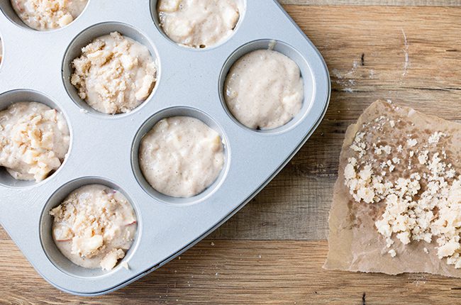 Overhead picture of apple muffin batter in muffin tin