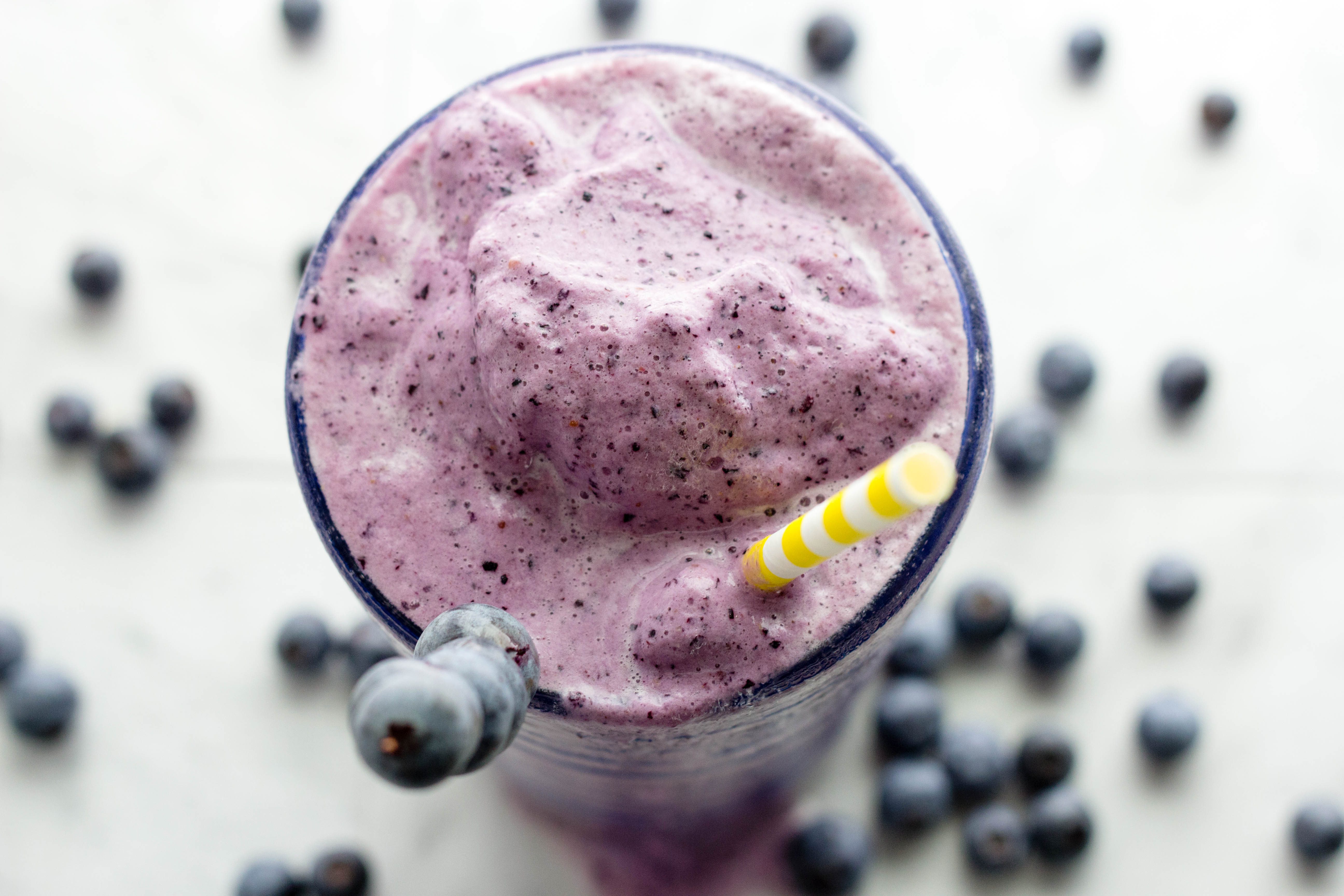 Overhead picture of top of glass filled with blueberry smoothie