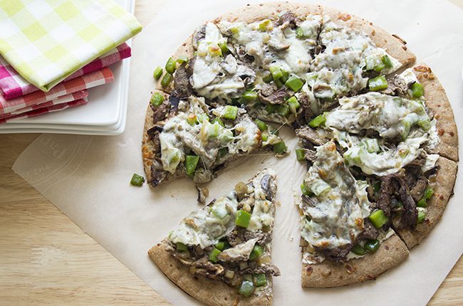 Philly cheesesteak pizza baked and sliced