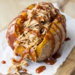 Up close picture of a stuffed sweet potato filled with bbq pulled pork