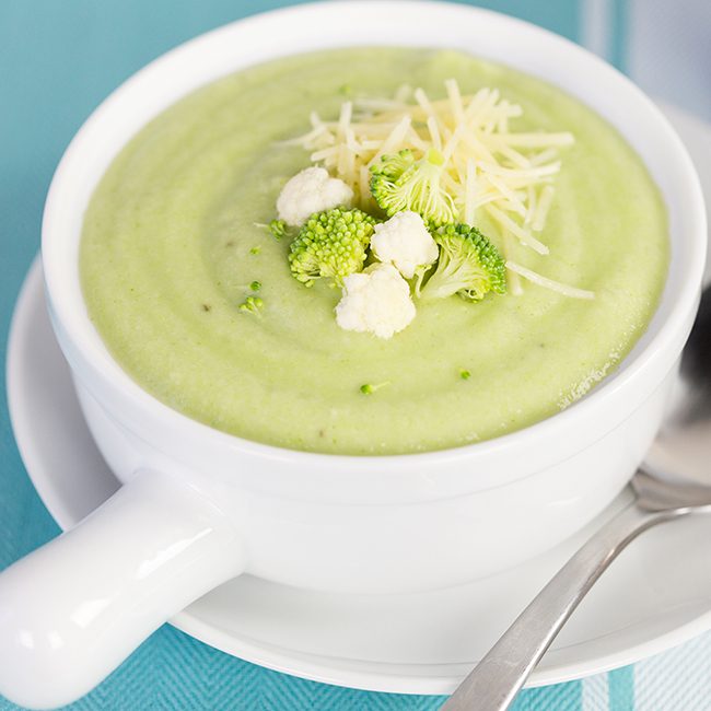 Up close picture of broccoli and cauliflower suop in large white bowl