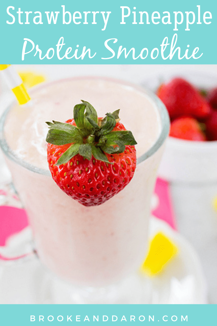 Up close picture of strawberry smoothie with strawberry garnish and pineapple