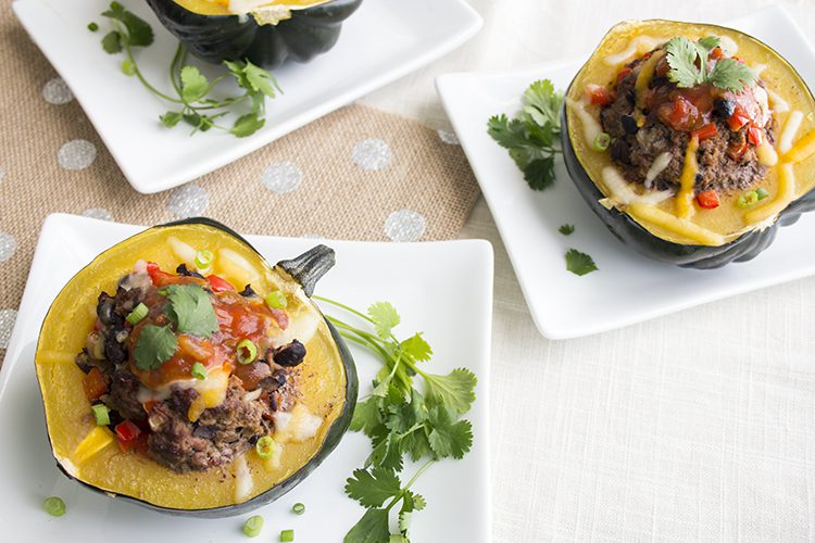 Healthy stuffed acorn squash on white plates