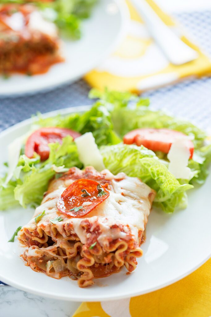 Lasagna roll ups on white plate