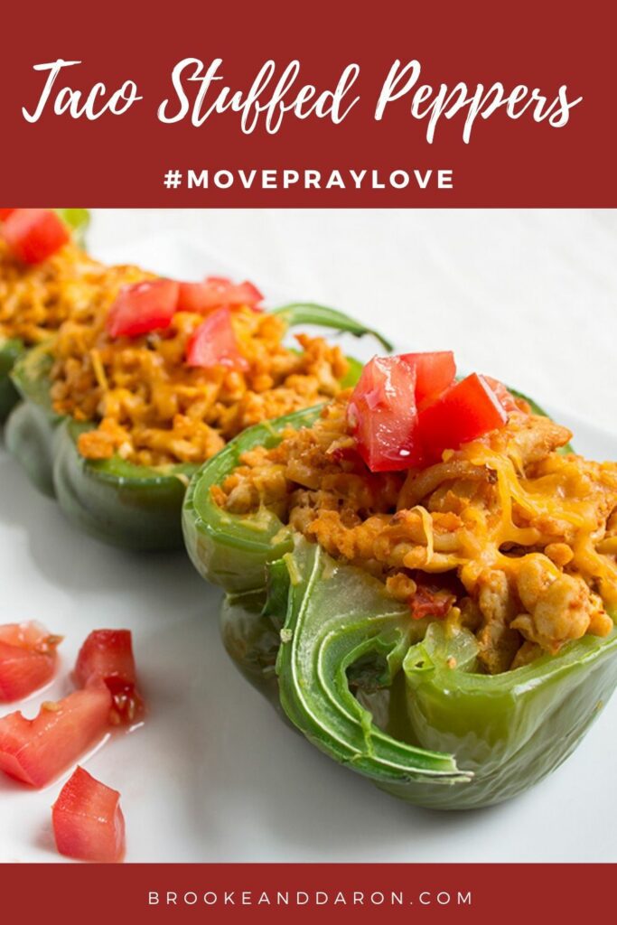 Three bell peppers stuffed with chicken on white plate