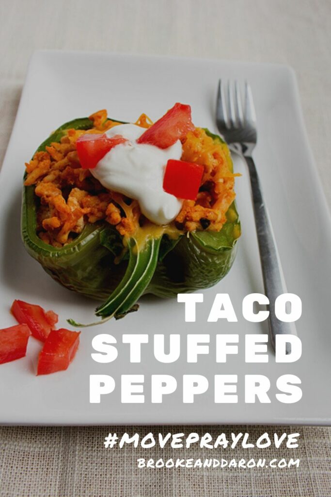 Single green bell pepper on white plate with fork