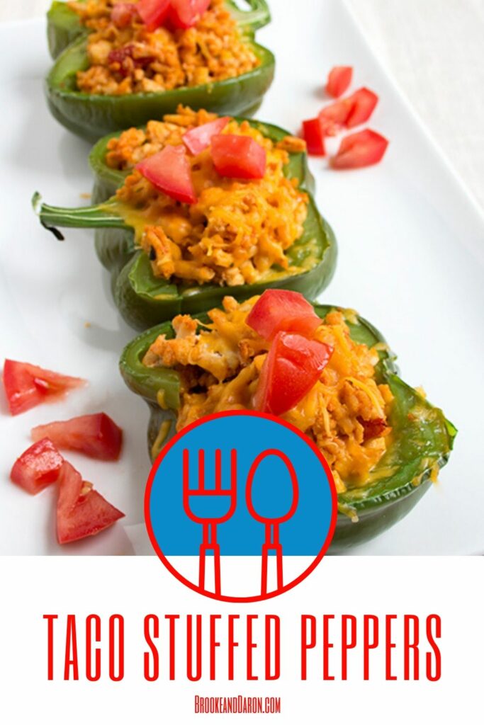 Three bell peppers stuffed with chicken on white plate